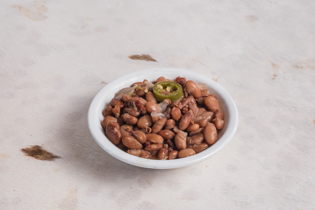 a close-up image of a small bowl of jalapeno pinto beans