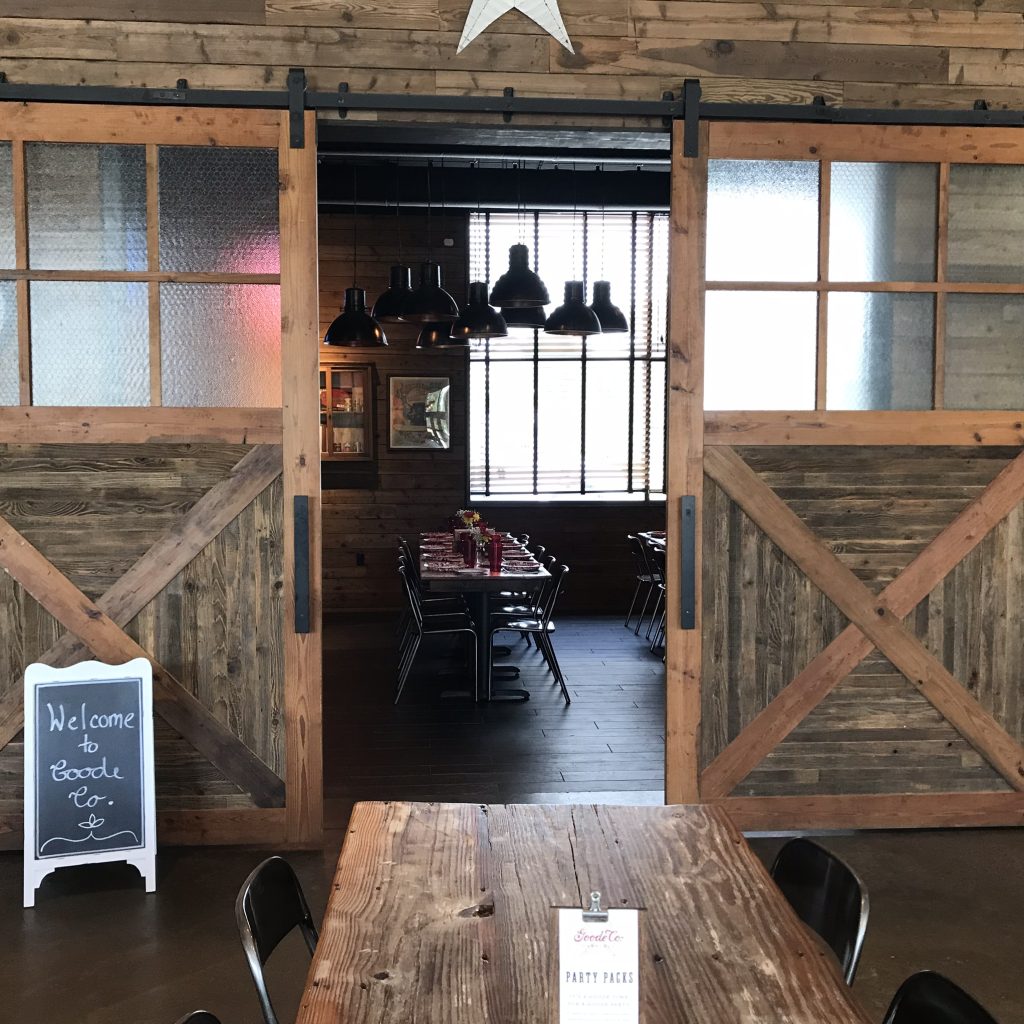 Welcome to Goode Co. Sign on board and entryway into private dining space.