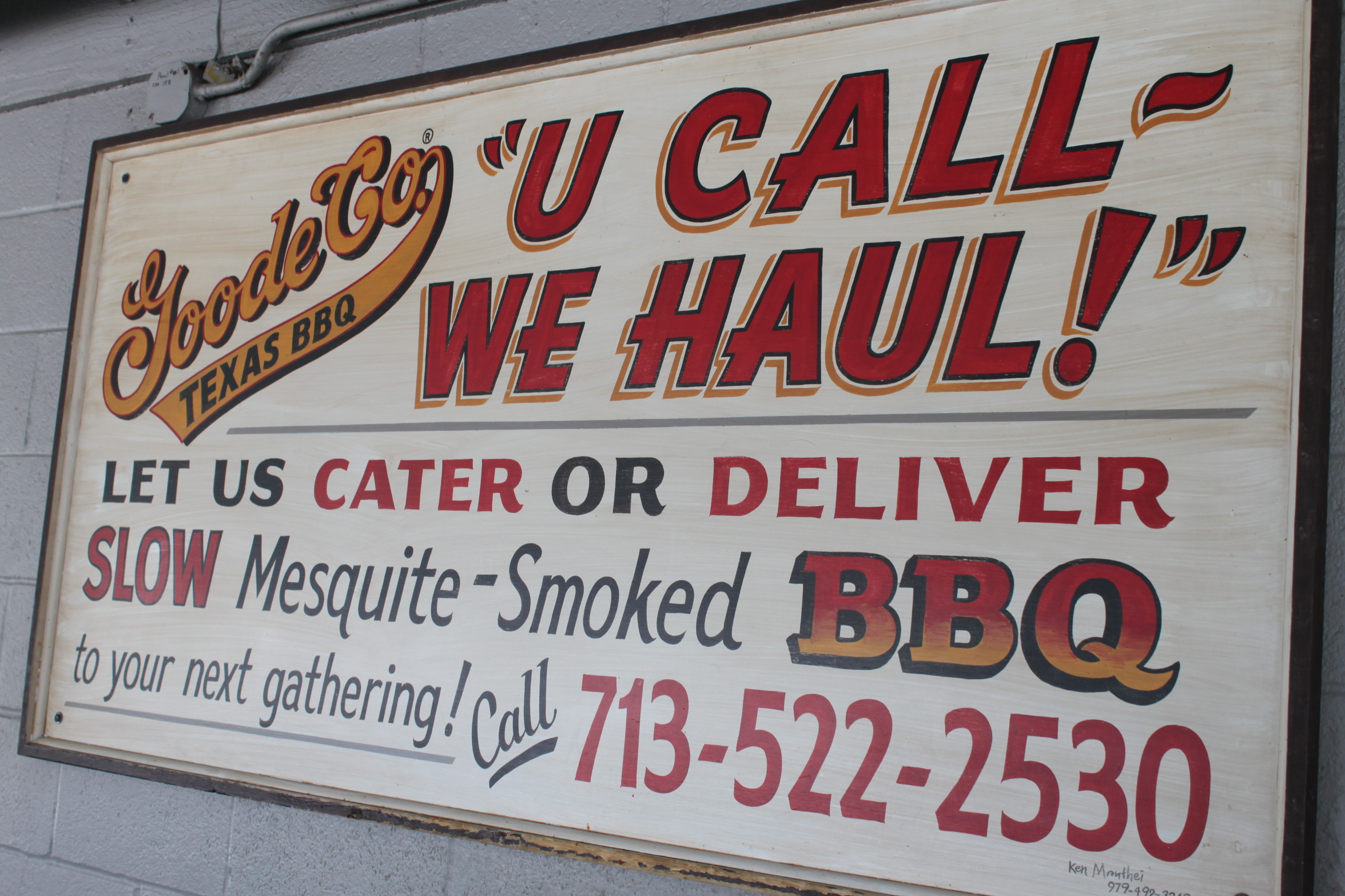 A Goode Co. BBQ sign featuring phone number and slogan